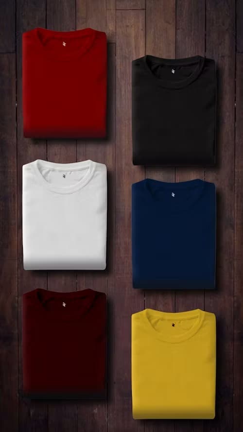 Row of sage green organic cotton crew-neck t-shirts on wooden hangers