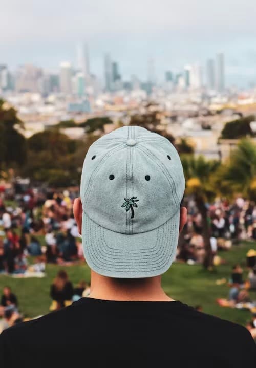 White structured snapback cap photographed against a plain grey background