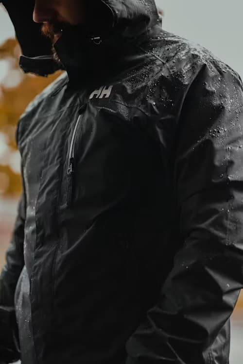 Close detail of a black leather biker jacket with silver zips and hardware